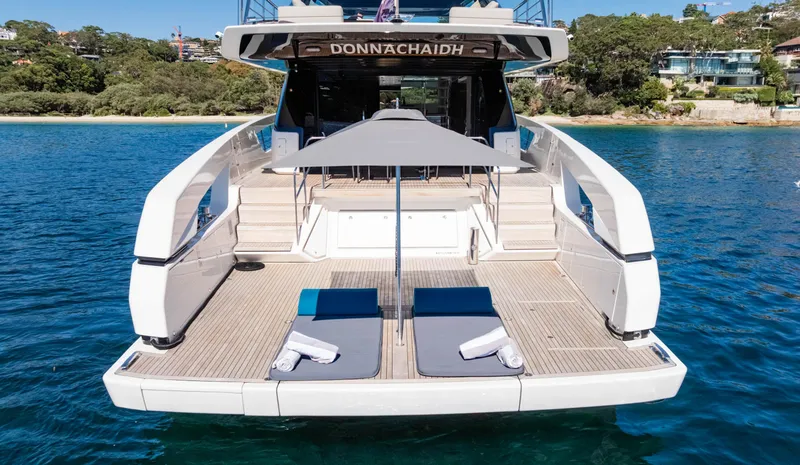 Donnachaidh Yacht Photos Pics Luxury Sanlorenzo SX76 yacht, 2020 model, with sun loungers and umbrella on deck.