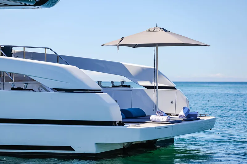 Donnachaidh Yacht Photos Pics Sanlorenzo SX76 yacht 2020, featuring a sun deck with umbrella, on calm blue waters.