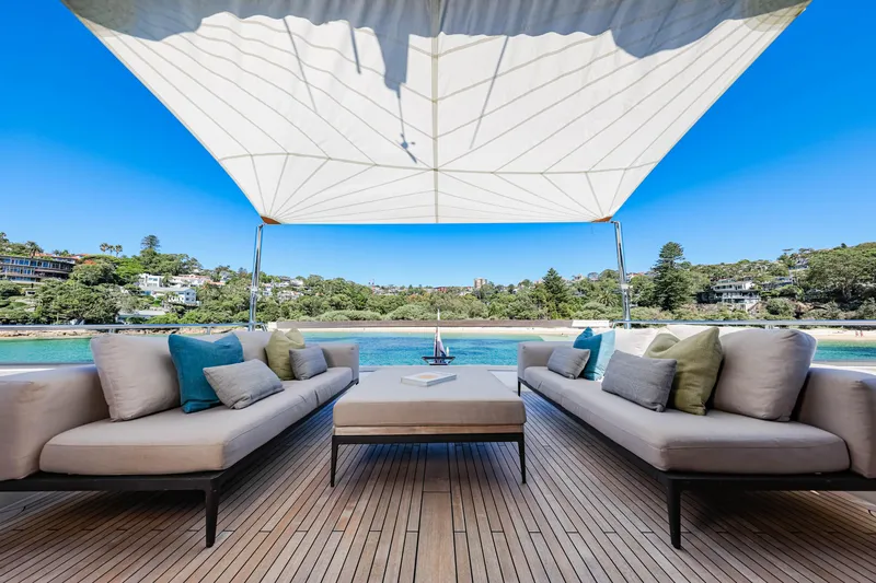 Donnachaidh Yacht Photos Pics Luxury Sanlorenzo SX76 yacht deck with elegant seating, 2020 model, overlooking serene waters and lush greenery.