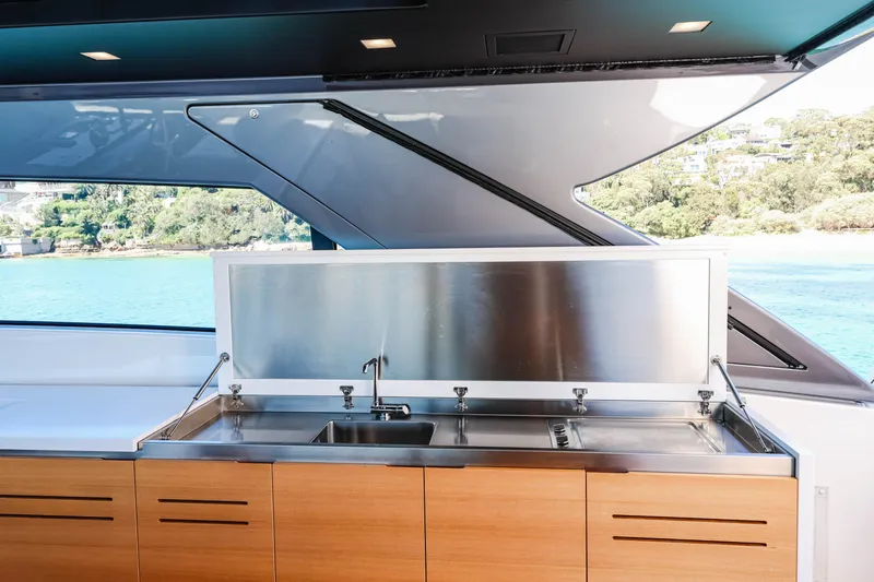 Donnachaidh Yacht Photos Pics Outdoor kitchen on 2020 Sanlorenzo SX76 yacht with stainless steel sink and wooden cabinetry.