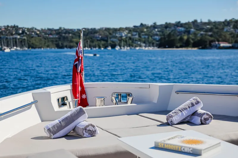 Donnachaidh Yacht Photos Pics Luxurious Sanlorenzo SX76 yacht deck with towels and book, overlooking serene waters.