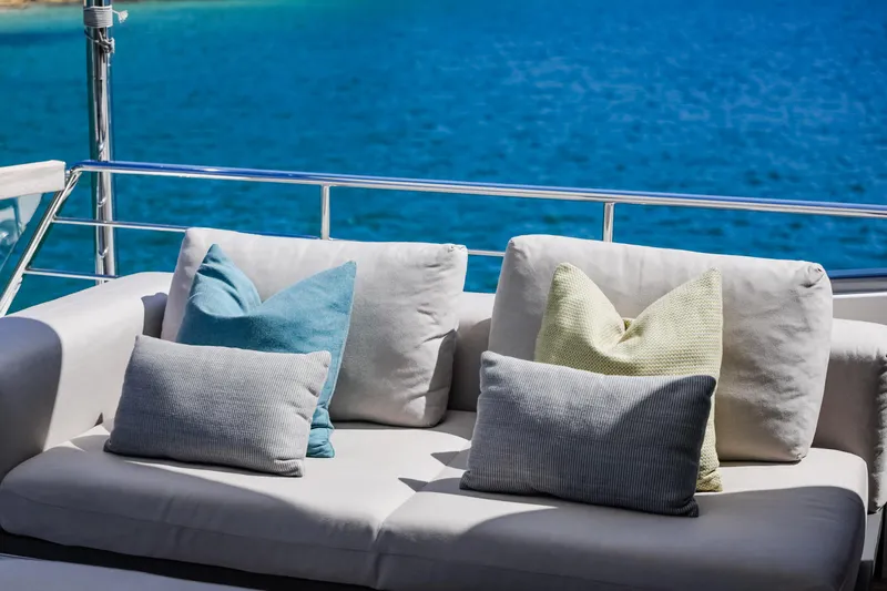 Donnachaidh Yacht Photos Pics Luxurious Sanlorenzo SX76 yacht deck with plush cushions, overlooking vibrant blue sea, 2020 model.