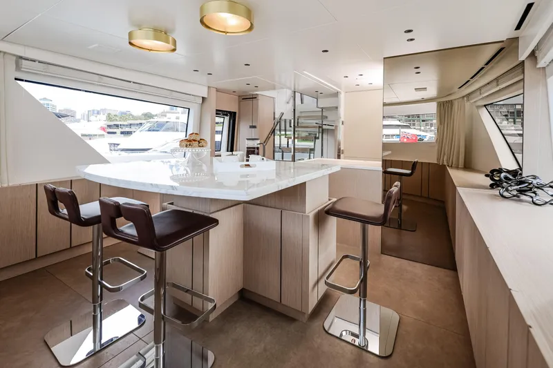 Donnachaidh Yacht Photos Pics Luxurious interior of 2020 Sanlorenzo SX76 yacht with modern dining area and panoramic windows.