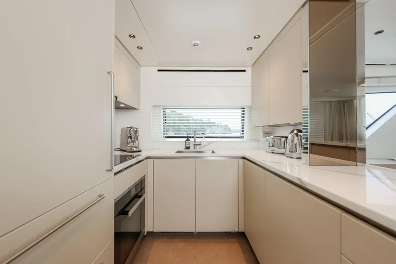 Donnachaidh Yacht Photos Pics Modern kitchen interior on 2020 Sanlorenzo SX76 yacht, featuring sleek cabinetry and stainless steel appliances.