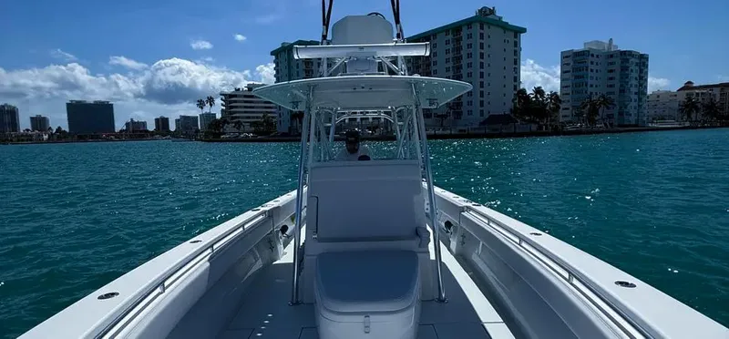  Yacht Photos Pics 2022 Contender 39 ST boat cruising on clear blue water near city skyline.