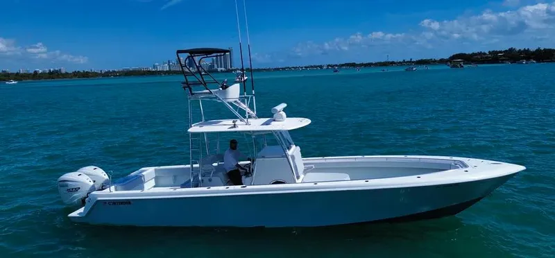  Yacht Photos Pics 2022 Contender 39 ST boat on clear blue water under a sunny sky.