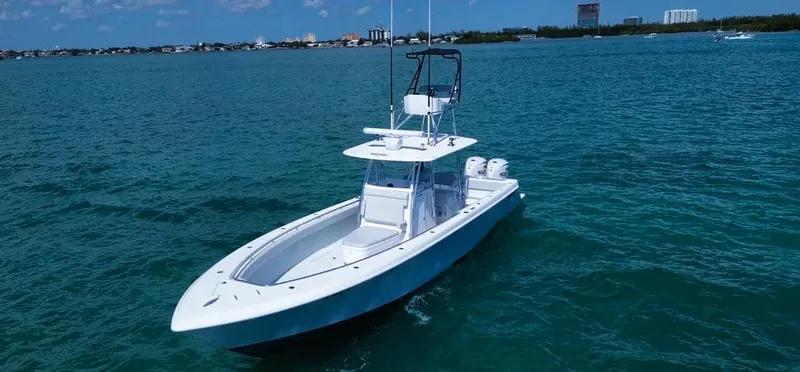  Yacht Photos Pics 2022 Contender 39 ST boat on open water, clear sky, distant shoreline.