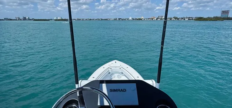  Yacht Photos Pics 2022 Contender 39 ST boat on clear blue water with city skyline in background.