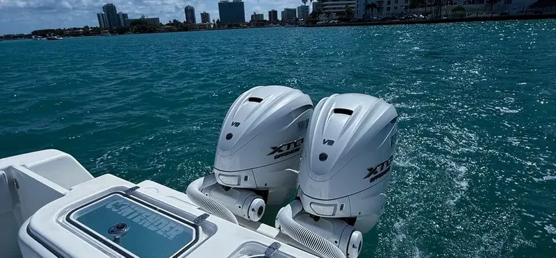  Yacht Photos Pics 2022 Contender 39 ST boat with twin outboard engines on blue water.