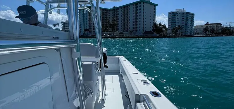  Yacht Photos Pics 2022 Contender 39 ST boat cruising on blue waters near urban skyline.
