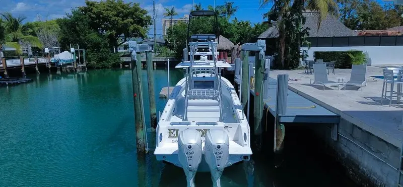  Yacht Photos Pics 2022 Contender 39 ST boat docked in a scenic marina setting.
