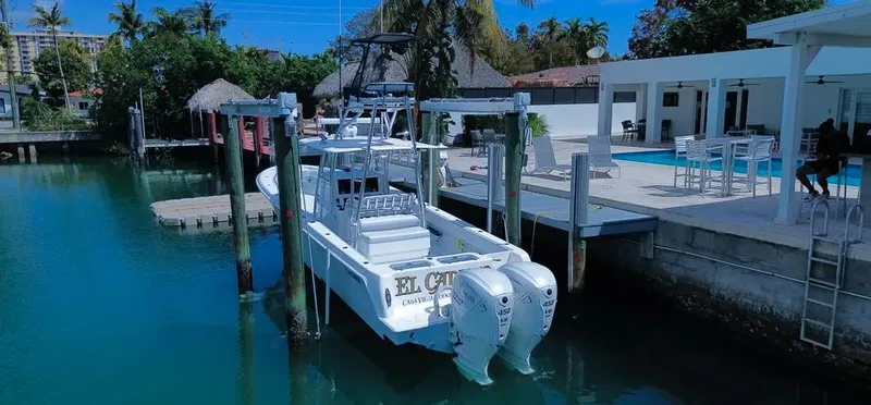  Yacht Photos Pics 2022 Contender 39 ST boat docked by a waterfront property with a pool.