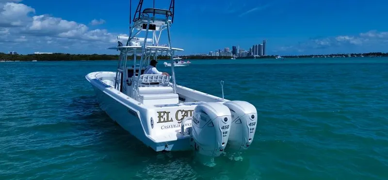  Yacht Photos Pics 2022 Contender 39 ST boat on blue water with city skyline in background.