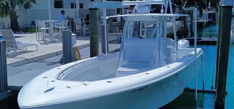  Yacht Photos Pics 2022 Contender 39 ST boat docked in a marina, showcasing sleek design and modern features.