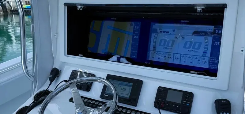 Yacht Photos Pics 2022 Contender 39 ST boat dashboard with navigation screens and controls.