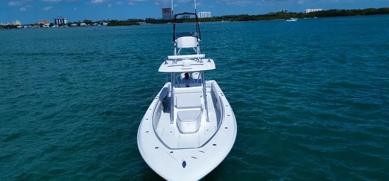  Yacht Photos Pics 2022 Contender 39 ST boat on clear blue water, showcasing sleek design and spacious deck.