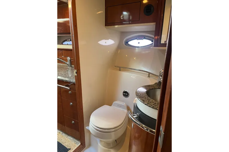  Yacht Photos Pics 2005 Sea Ray 390 Express Cruiser bathroom with modern fixtures and wood cabinetry.