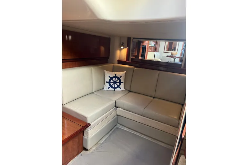  Yacht Photos Pics Interior of 2005 Sea Ray 390 Express Cruiser with beige seating and nautical-themed pillow.