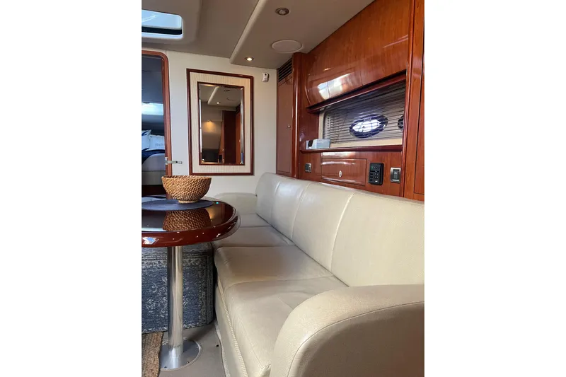  Yacht Photos Pics Interior of 2005 Sea Ray 390 Express Cruiser with beige seating and wooden accents.