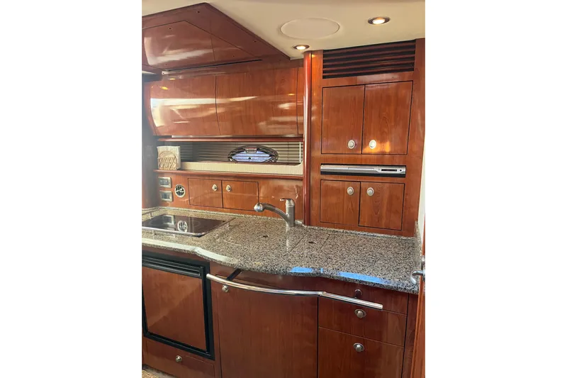  Yacht Photos Pics Luxurious 2005 Sea Ray 390 Express Cruiser kitchen with wood cabinetry and granite countertops.