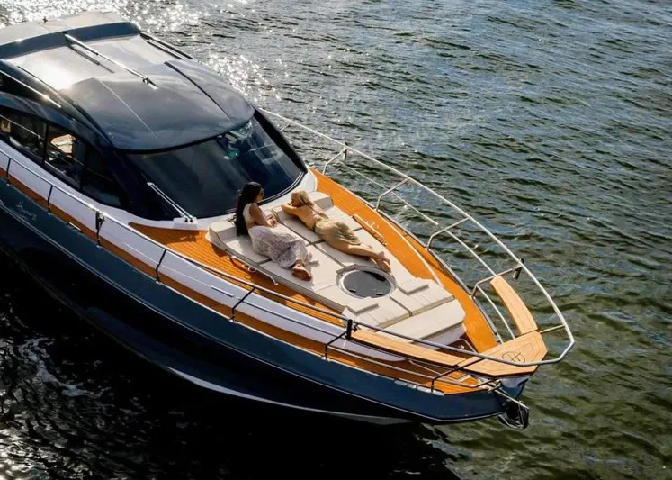  Yacht Photos Pics Luxury Hanover 415 yacht, 2025 model, with two people relaxing on deck, cruising on water.