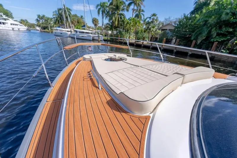  Yacht Photos Pics Luxurious Hanover 415 yacht deck with sunbed, docked near lush greenery, 2025 model.