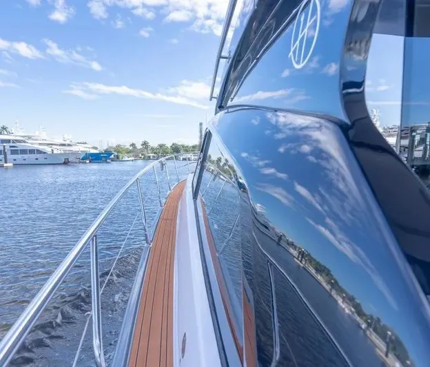  Yacht Photos Pics Sleek Hanover 415 yacht on water, reflecting blue sky and clouds, 2025 model.