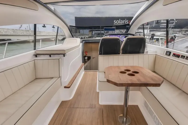  Yacht Photos Pics Luxurious interior of 2025 Hanover 415 yacht with elegant seating and wooden table.