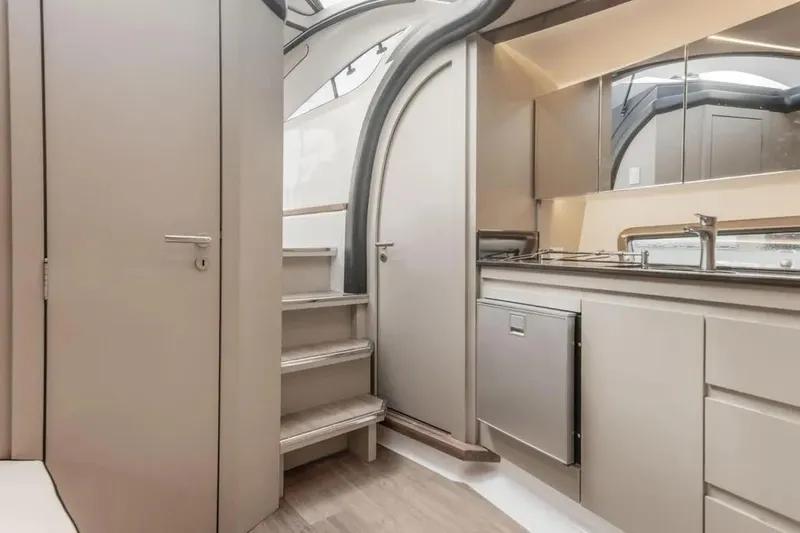  Yacht Photos Pics Modern interior of Hanover 415 yacht, featuring sleek kitchen and staircase, 2025 model.