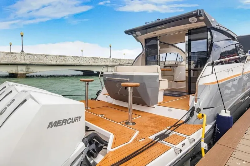  Yacht Photos Pics 2025 Hanover 415 yacht docked, featuring Mercury engines and sleek design under a blue sky.