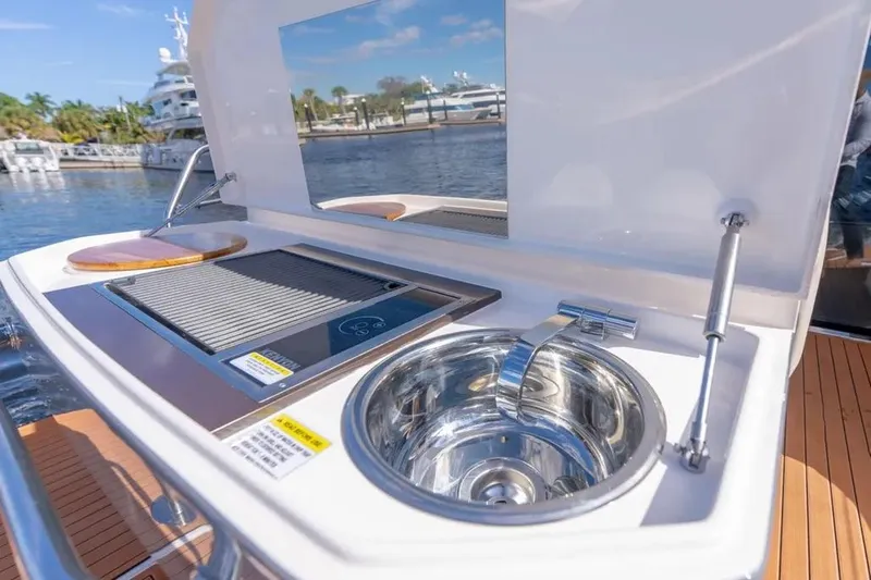  Yacht Photos Pics Outdoor kitchen on a 2025 Hanover 415 yacht with sink and grill by the water.