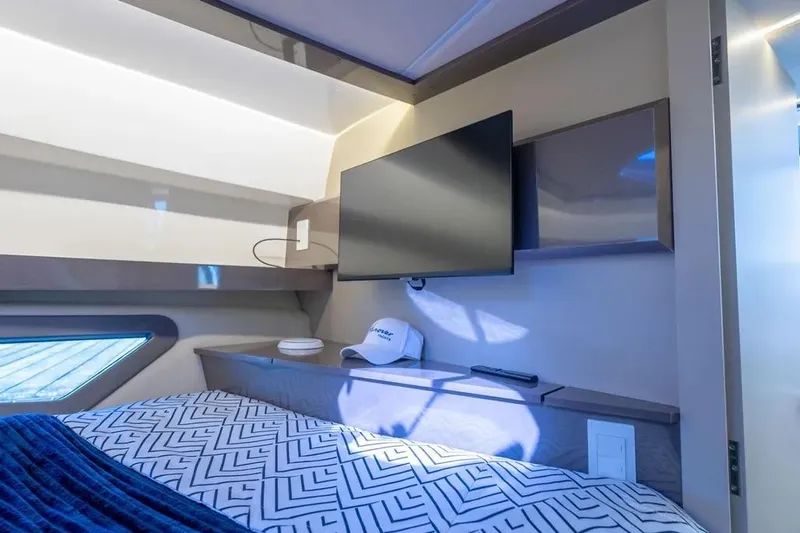  Yacht Photos Pics Luxurious interior of 2025 Hanover 415 yacht with modern TV and stylish bedding.