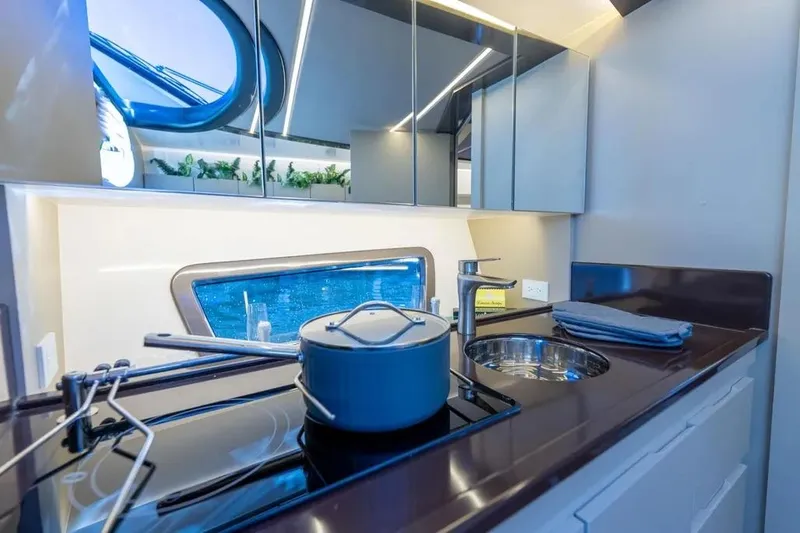  Yacht Photos Pics Modern kitchen interior on Hanover 415 yacht, featuring sleek design and ocean view window.