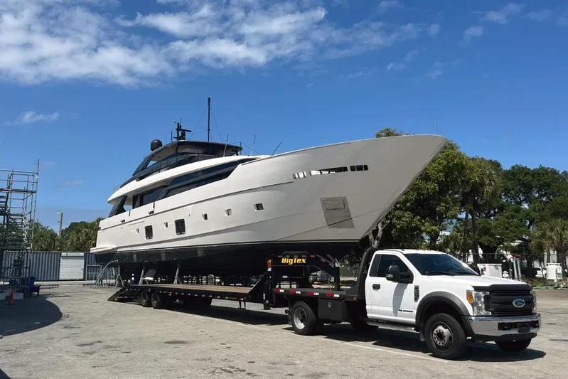  Yacht Photos Pics 2022 Sanlorenzo SL 120A yacht on trailer, parked outdoors under clear blue sky.