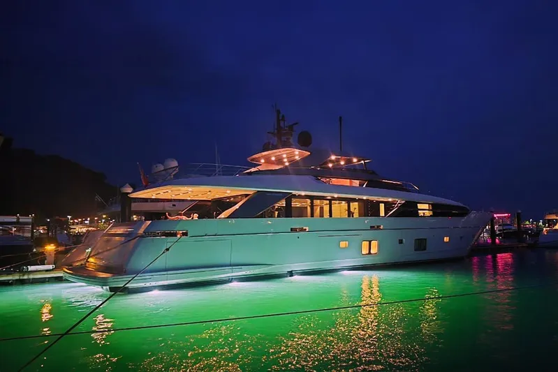  Yacht Photos Pics Luxurious 2022 Sanlorenzo SL 120A yacht illuminated at night in a marina.