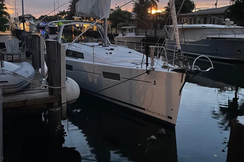 Deli Mavi Yacht Photos Pics 2019 Beneteau Oceanis 41.1 sailboat docked at sunset, reflecting on calm water.