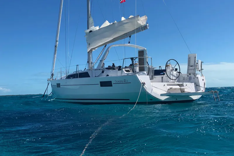 Deli Mavi Yacht Photos Pics 2019 Beneteau Oceanis 41.1 sailboat on clear blue ocean under sunny sky.