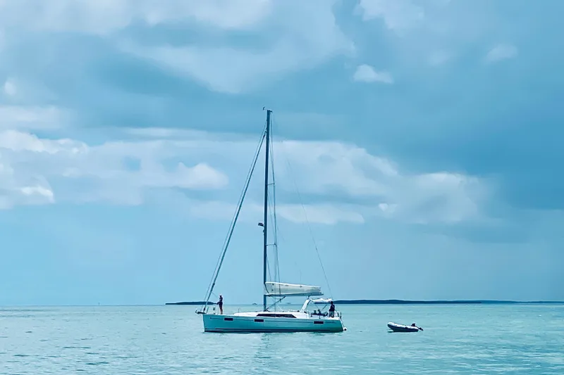 Deli Mavi Yacht Photos Pics 2019 Beneteau Oceanis 41.1 sailboat on calm sea under cloudy sky.