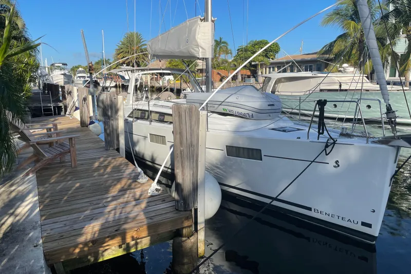 Deli Mavi Yacht Photos Pics 2019 Beneteau Oceanis 41.1 yacht docked at a sunny marina.