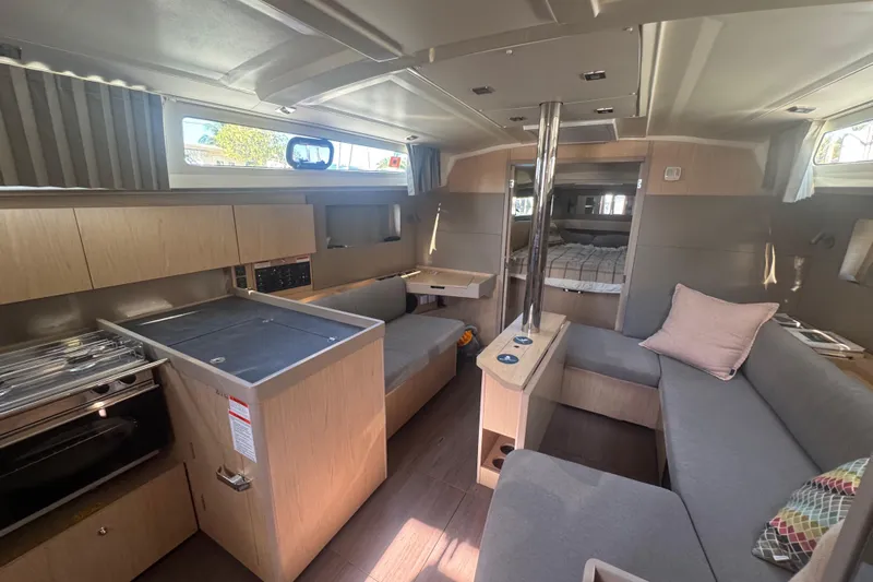 Deli Mavi Yacht Photos Pics Interior of 2019 Beneteau Oceanis 41.1 yacht with modern kitchen and cozy seating area.