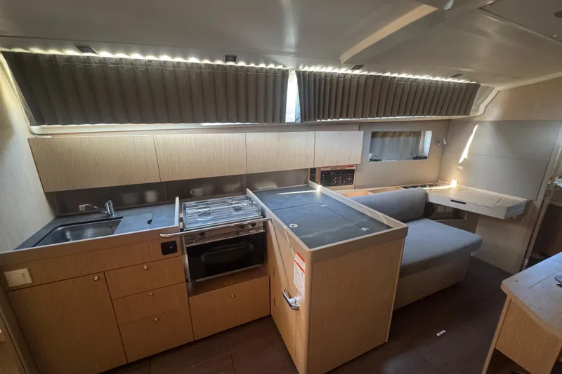 Deli Mavi Yacht Photos Pics Interior of 2019 Beneteau Oceanis 41.1 yacht, featuring modern kitchen and seating area.