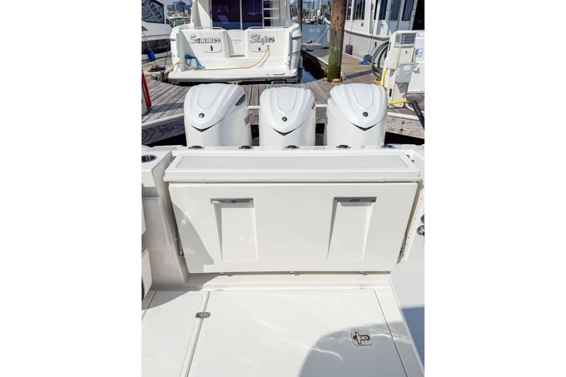  Yacht Photos Pics 2024 Pursuit DC 365 Dual Console boat with triple outboard engines at dock.