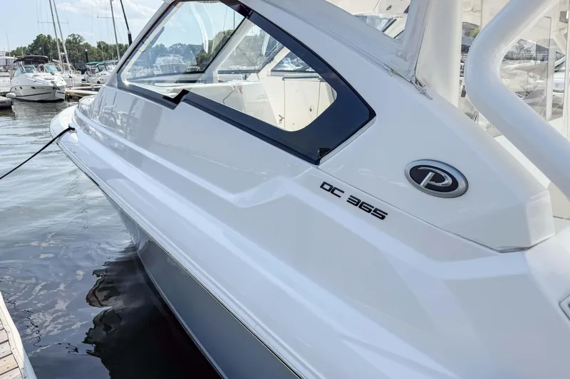  Yacht Photos Pics 2024 Pursuit DC 365 Dual Console boat docked at marina, side view.