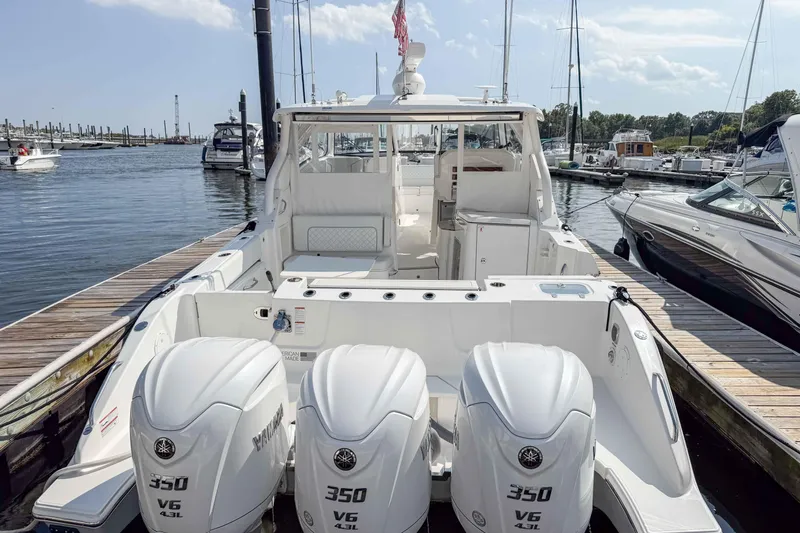  Yacht Photos Pics 2024 Pursuit DC 365 Dual Console boat with triple 350 V6 engines docked at marina.