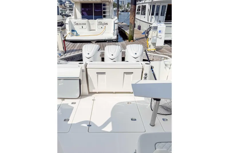  Yacht Photos Pics 2024 Pursuit DC 365 Dual Console boat docked, featuring triple outboard engines.