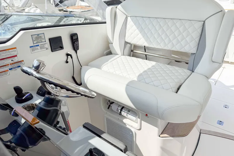  Yacht Photos Pics 2024 Pursuit DC 365 Dual Console helm with luxurious white seating and modern controls.