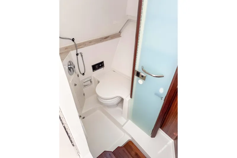  Yacht Photos Pics 2024 Pursuit DC 365 Dual Console boat bathroom with modern fixtures and sleek design.