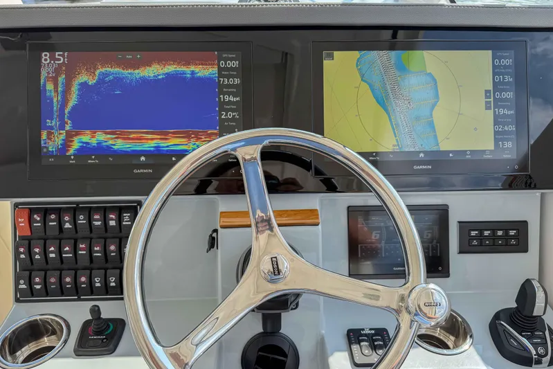  Yacht Photos Pics 2024 Pursuit DC 365 Dual Console dashboard with Garmin displays and steering wheel.