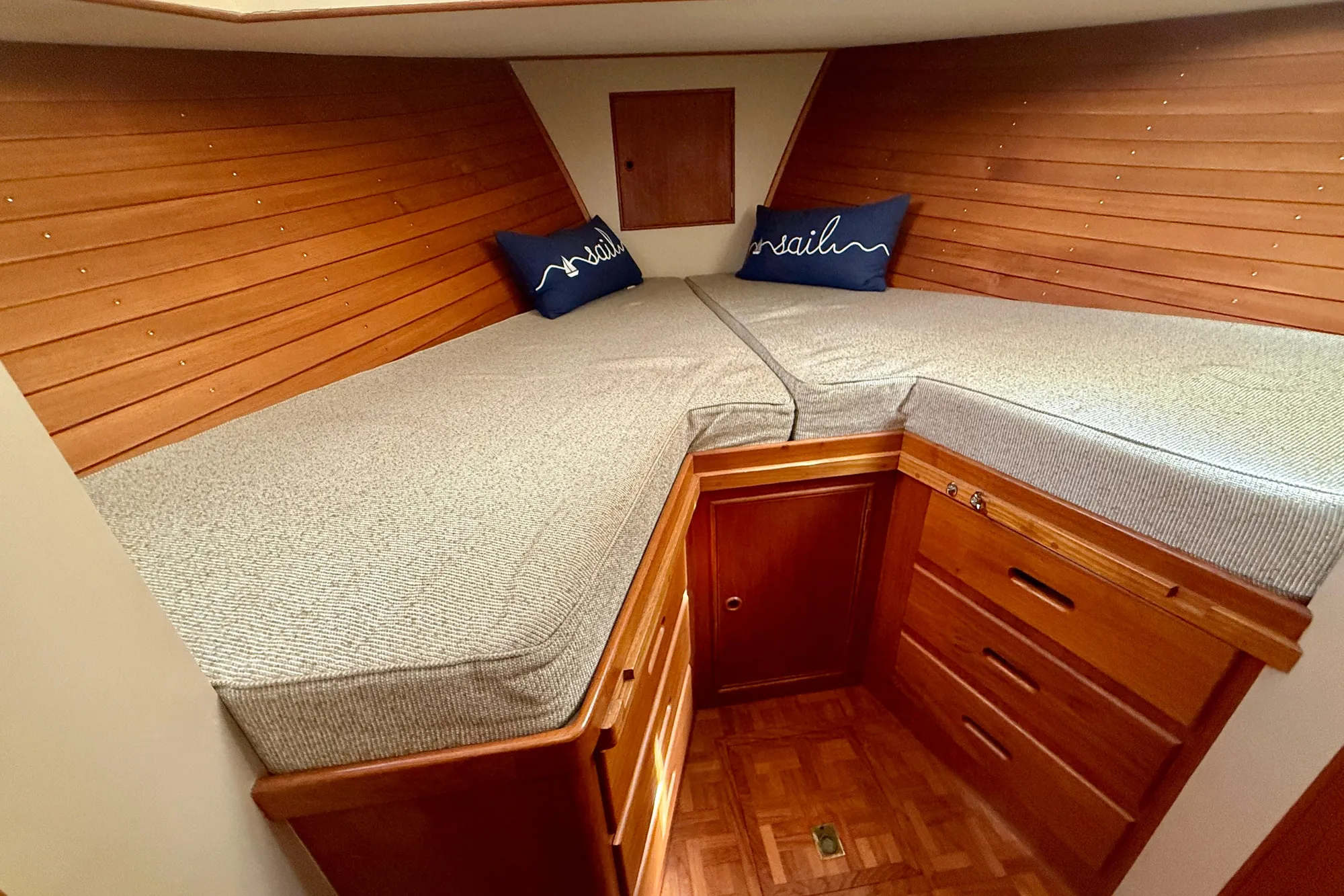 Cozy cabin interior of 1982 Grand Banks 42 Classic with wooden paneling and twin beds.