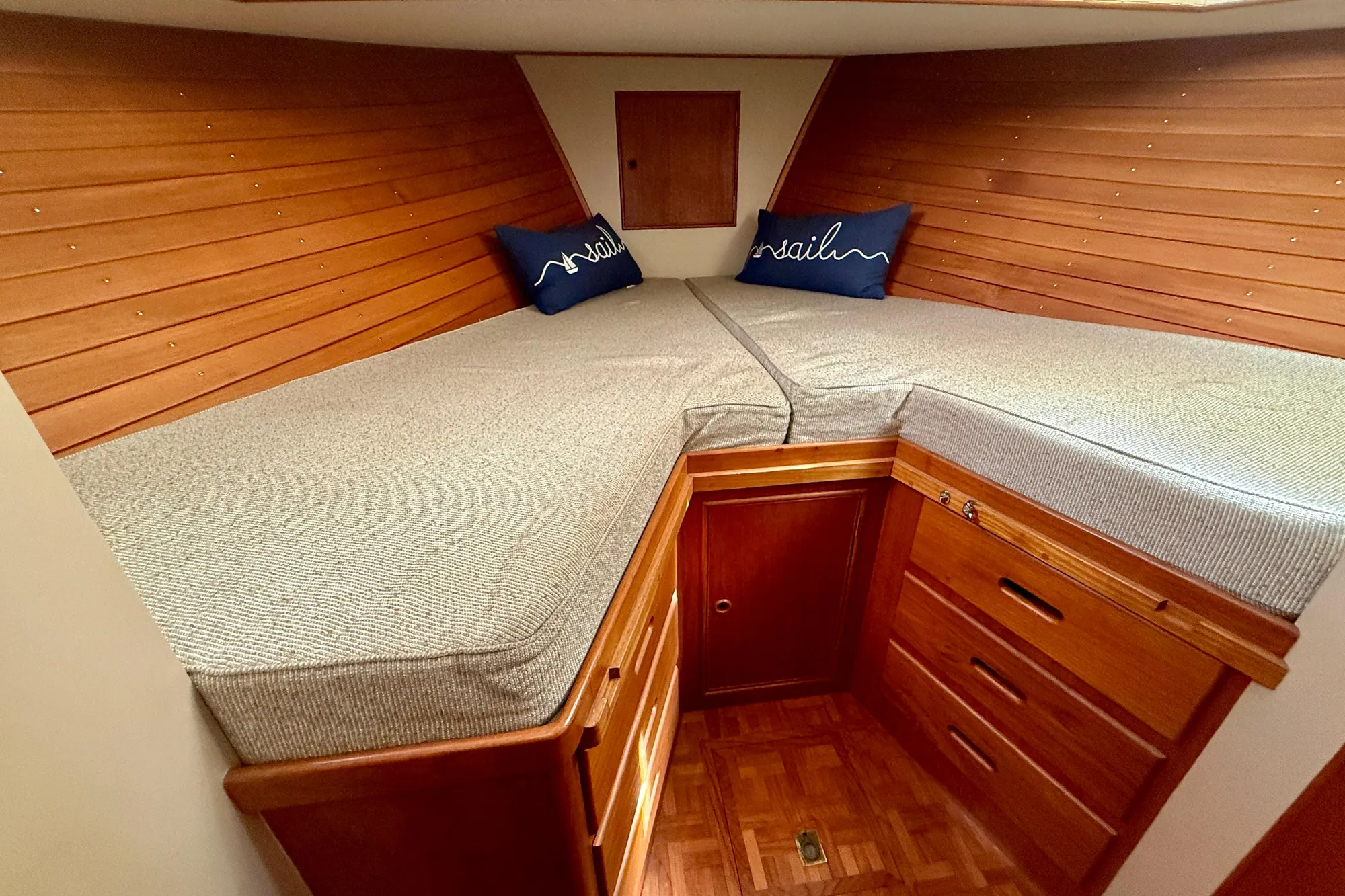 1982 Grand Banks 42 Classic cabin with wooden interior and cozy bedding.